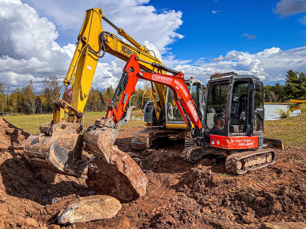 Choreguys excavators on a residential job, moving earth and rock